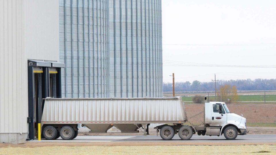 semi-truck leaving a silo
