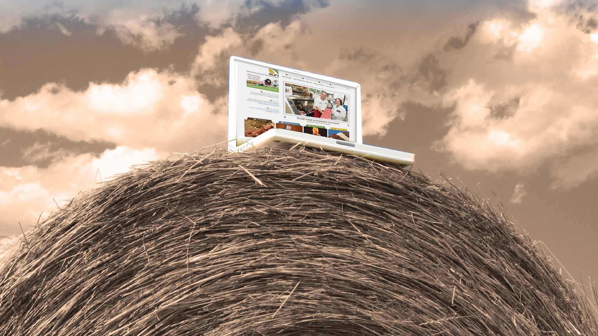 computer on top of a hay bale