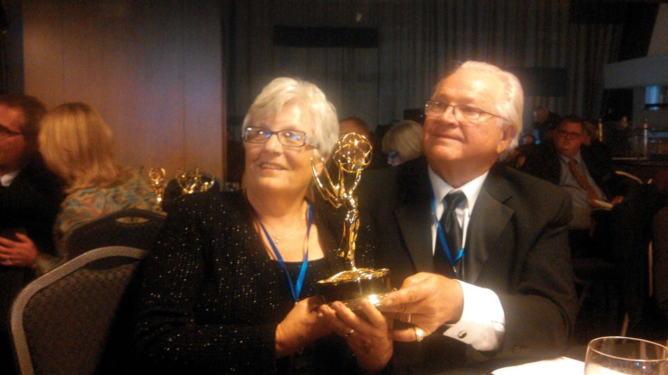 couple accepting an Emmy award