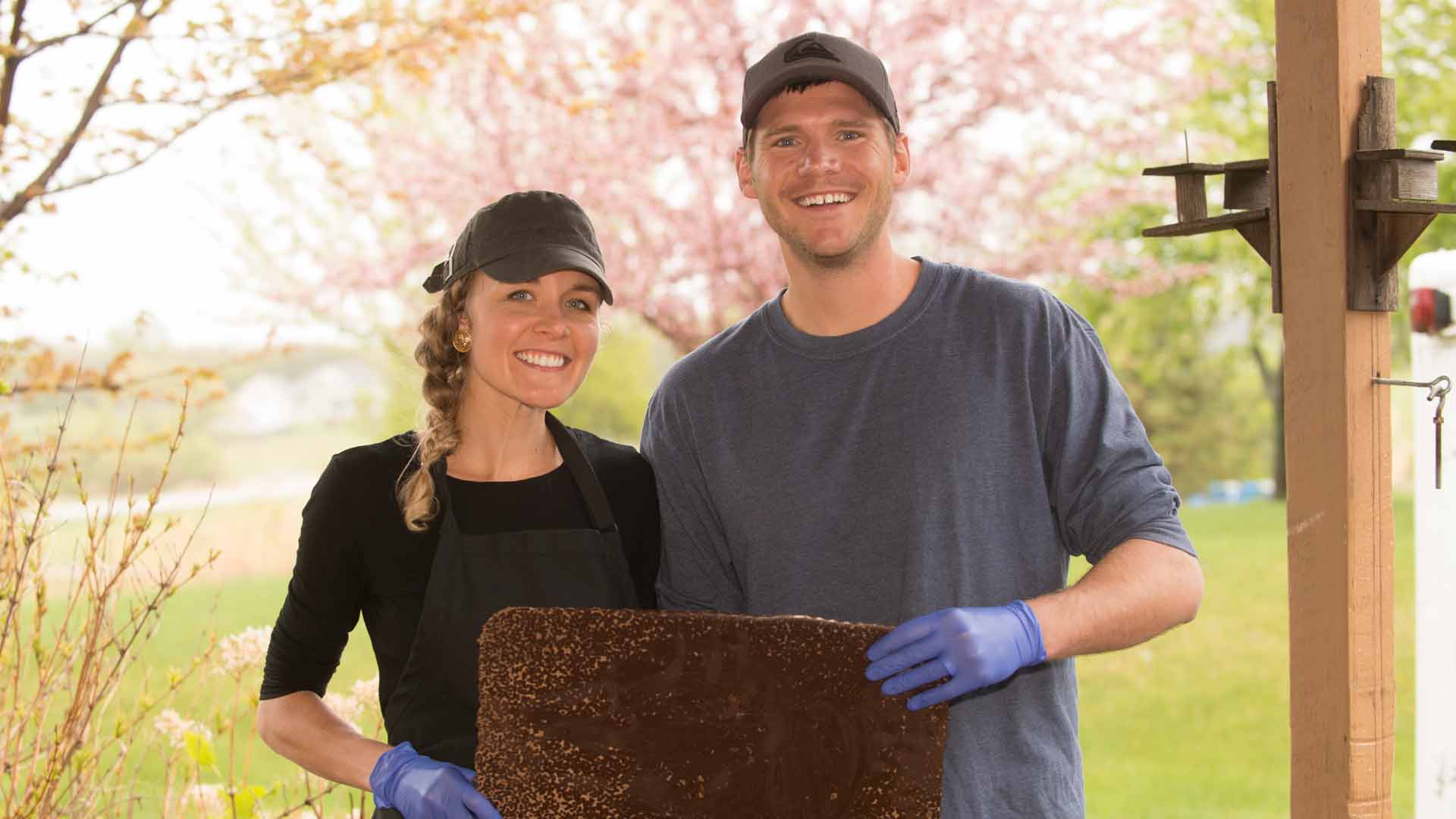 terroir chocolate owners holding large chunk of artisan chocolate