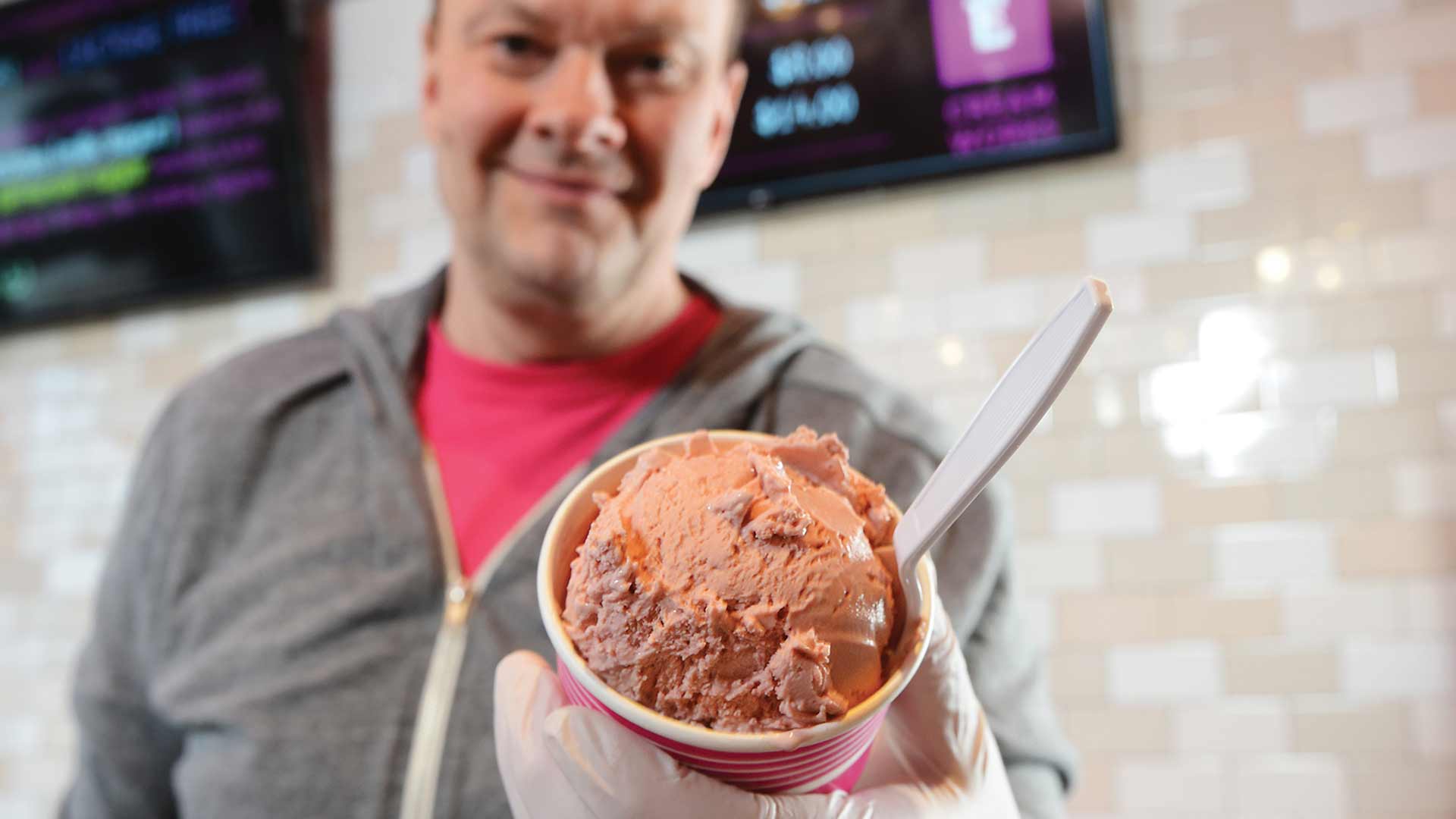 man holding cup of lactose-free ice cream