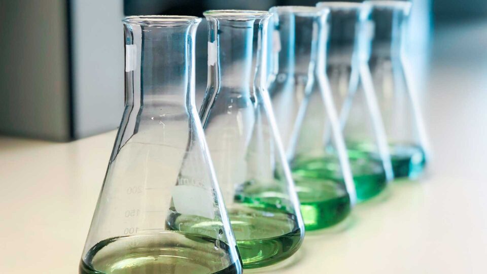 science beakers with green liquid