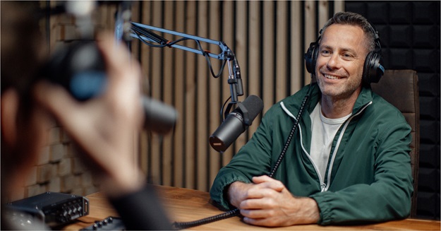 Photo of a guy in a podcast recording studio